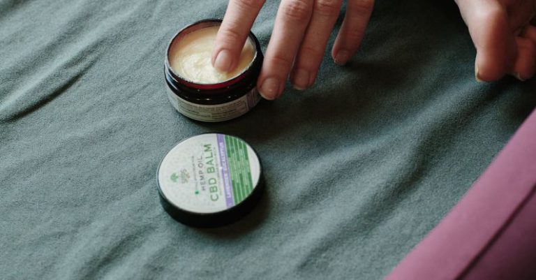 Pain Relievers - Person's Hand in a Wax Container