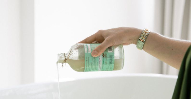 Skincare - Person Pouring Aromatic Soap On Water