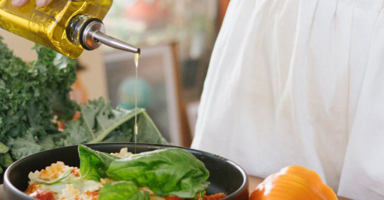 Cooking Oils - Photo Of Woman Pouring Liquid On Vegetable