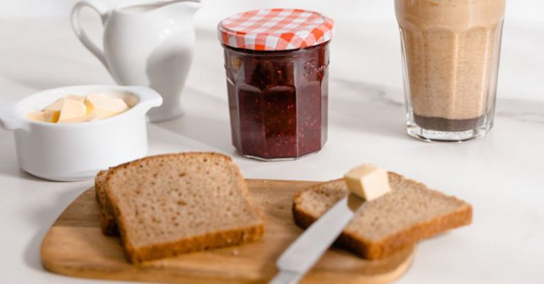 Spreads - Bread with Butter and Glass of Chocolate Milk on Table