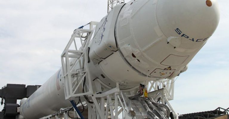 Energy Boosters - Rocket transporter parked at industrial factory